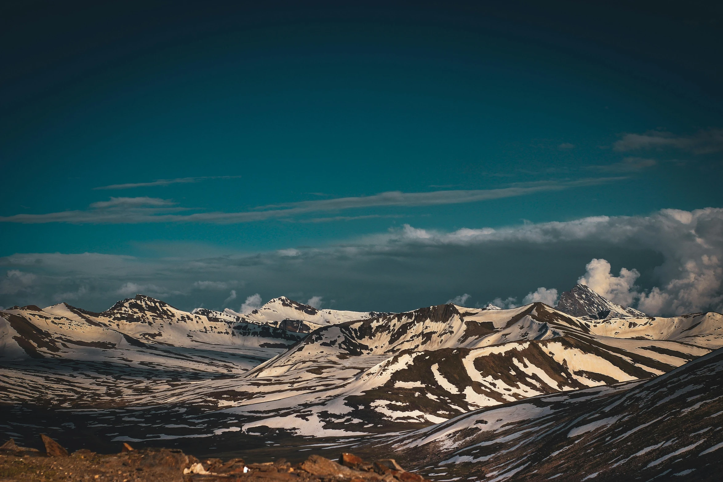 snowy mountain tops with one sky on the top