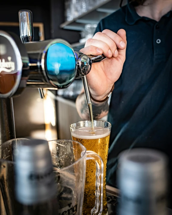 there is a bartender pouring a glass of beer