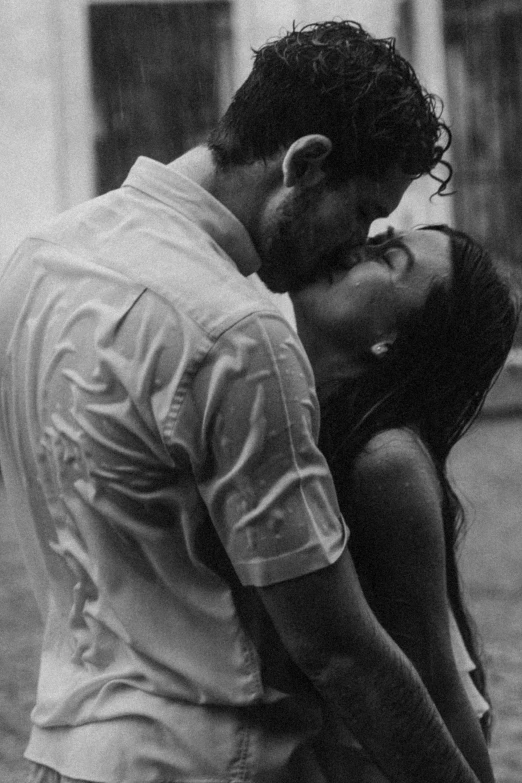 black and white po of a man kissing a woman on the forehead