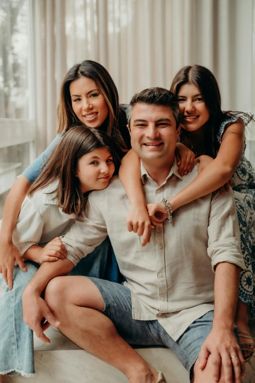 a family is sitting together on the sofa