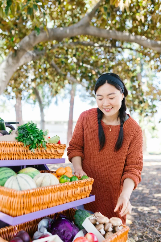 woman standing near fruits and vegetables at a farmer's market