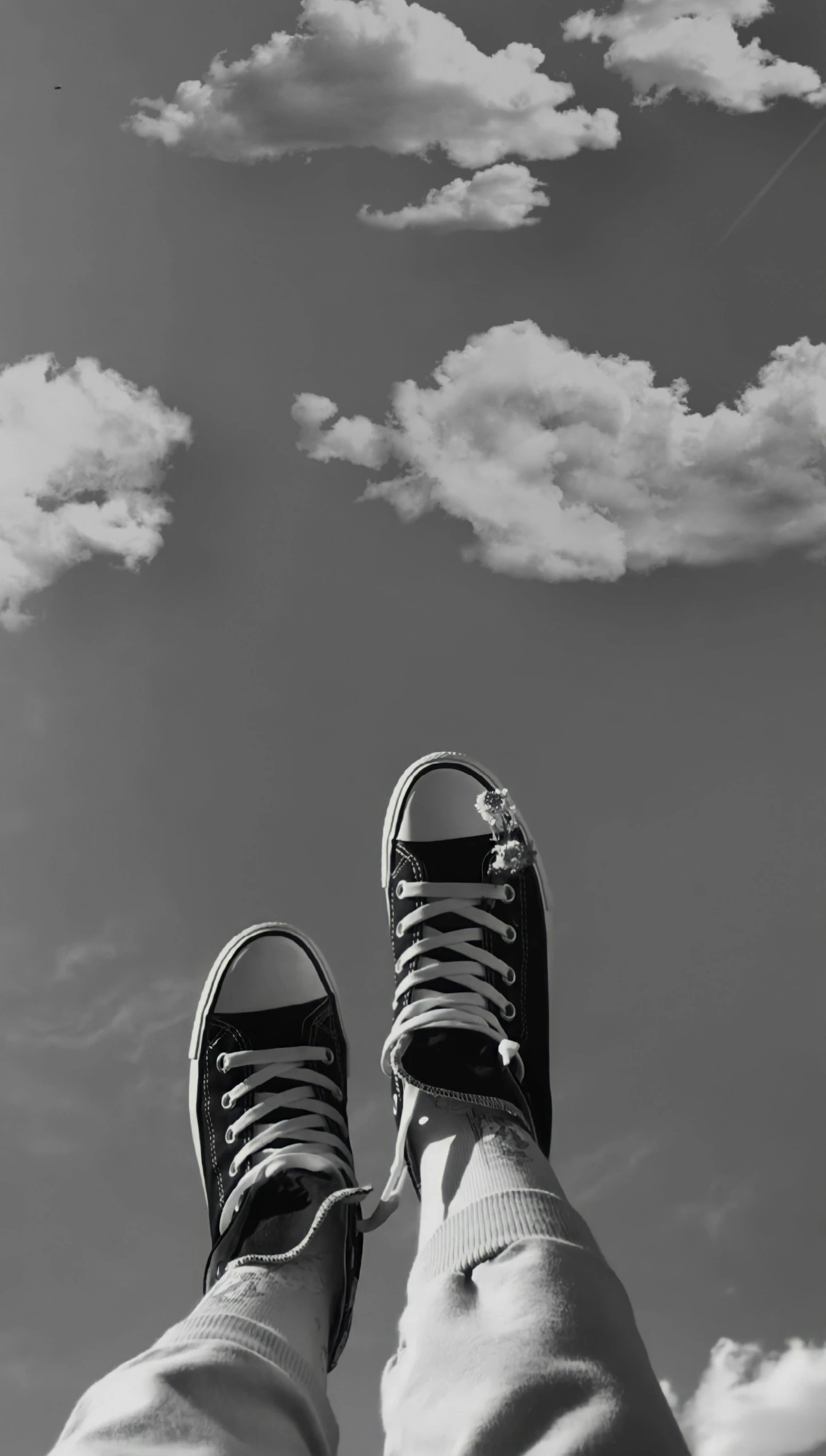 the view of a person with their feet up and showing some clouds