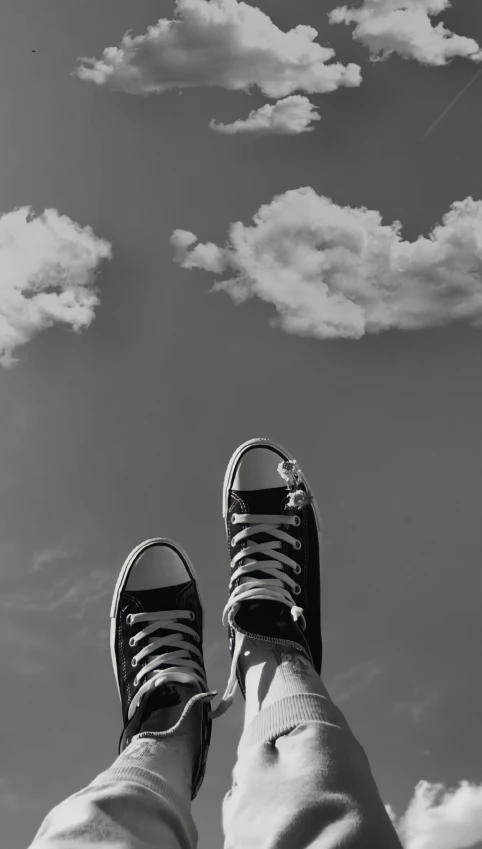 the view of a person with their feet up and showing some clouds