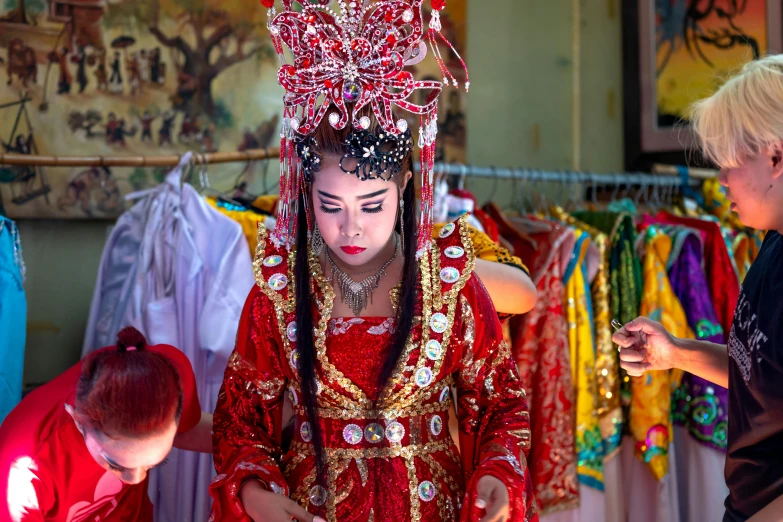 a woman in traditional costume is standing next to another person