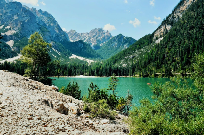 a mountain landscape with water surrounded by wooded area