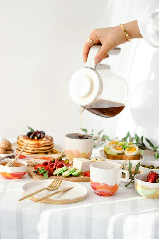 a lady pouring syrup onto a plate full of food