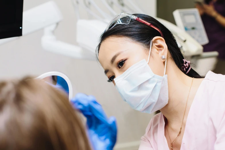 a young asian girl wearing a face mask