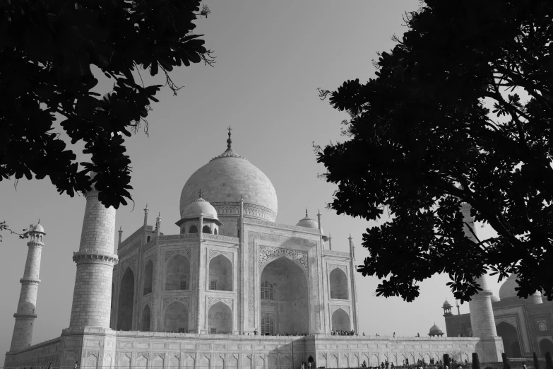 a black and white pograph of an old building with arches