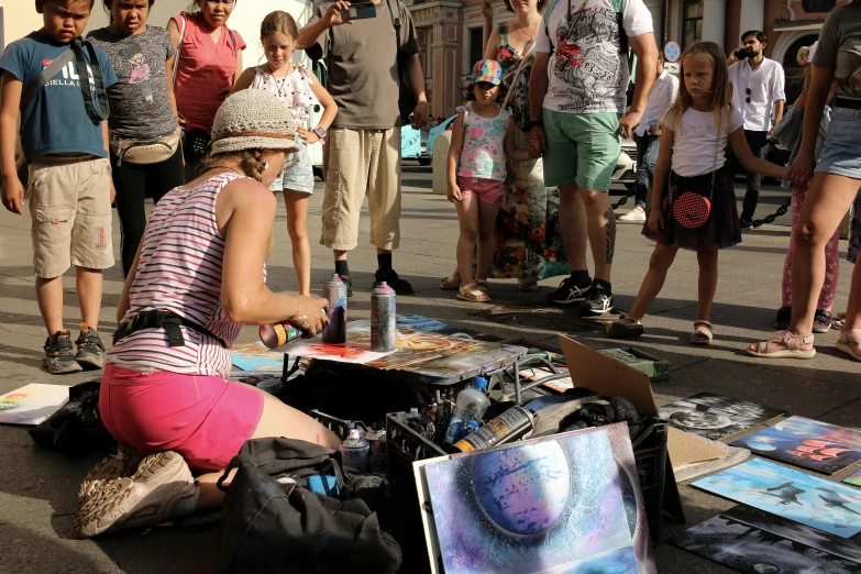 a woman sitting down next to a group of people