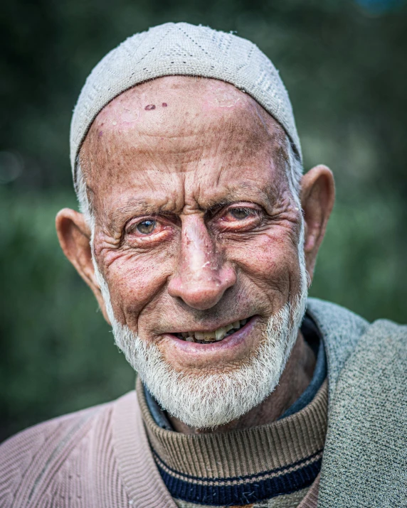 an older man smiles for the camera