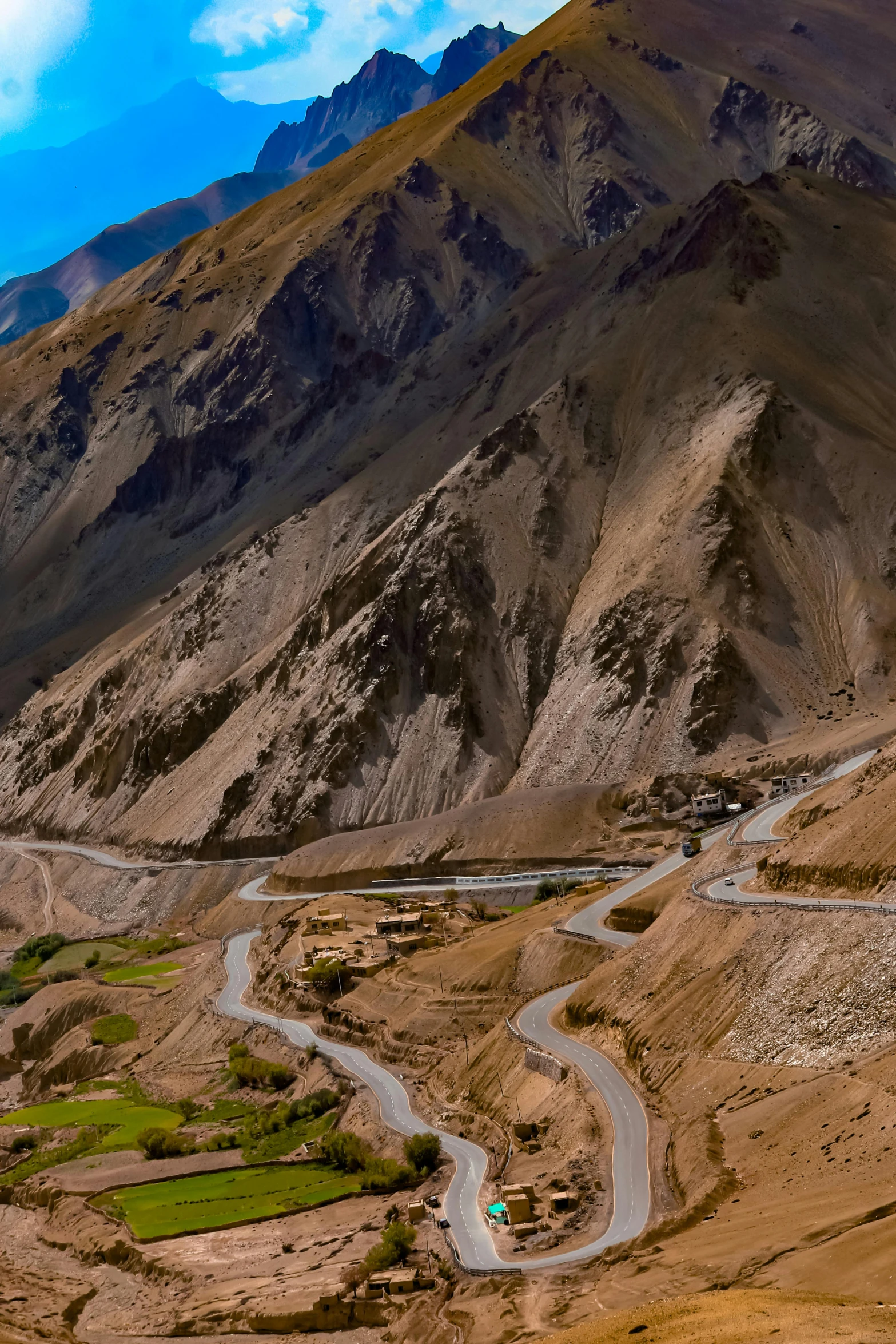 an amazing view of a mountain, road and a body of water