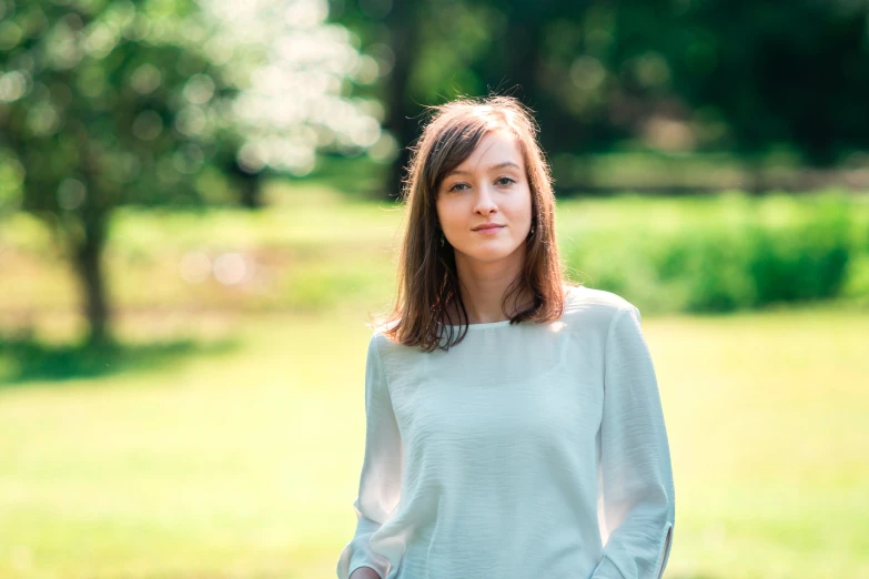 a girl is posing for a po in a field