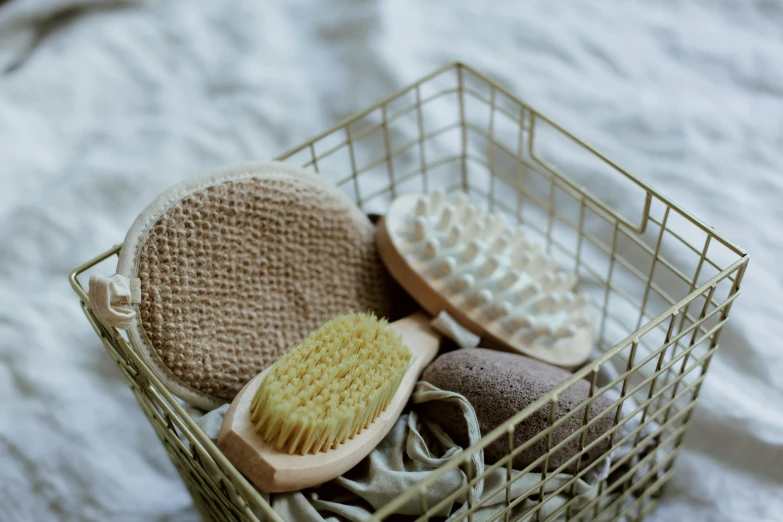 an image of soaps and hair brushes in a basket