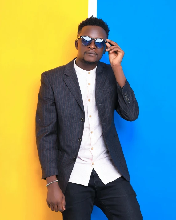 young african man posing in front of a brightly colored backdrop