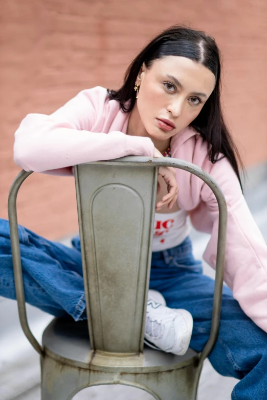  sitting on a metal bench at the city park