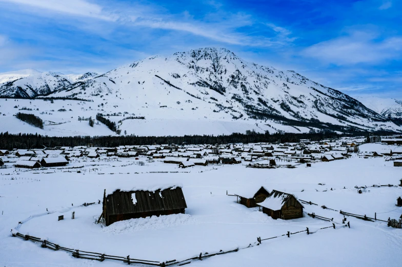 snowy mountains are the backdrop for an idyllic scene