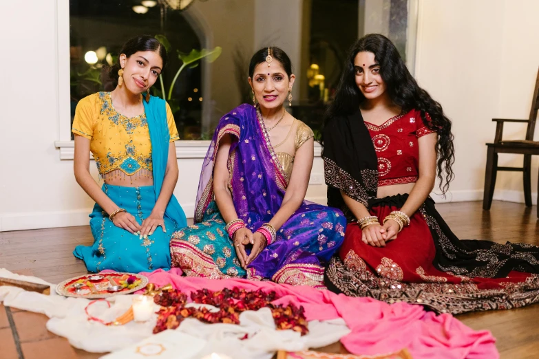 three women dressed in different ethnic and ethnic attire