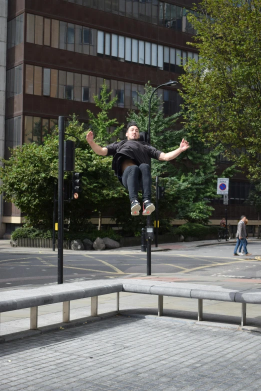 a man riding a skateboard on top of a metal pole