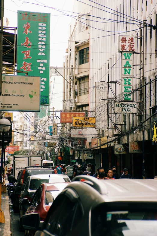 many cars are on the road next to tall buildings