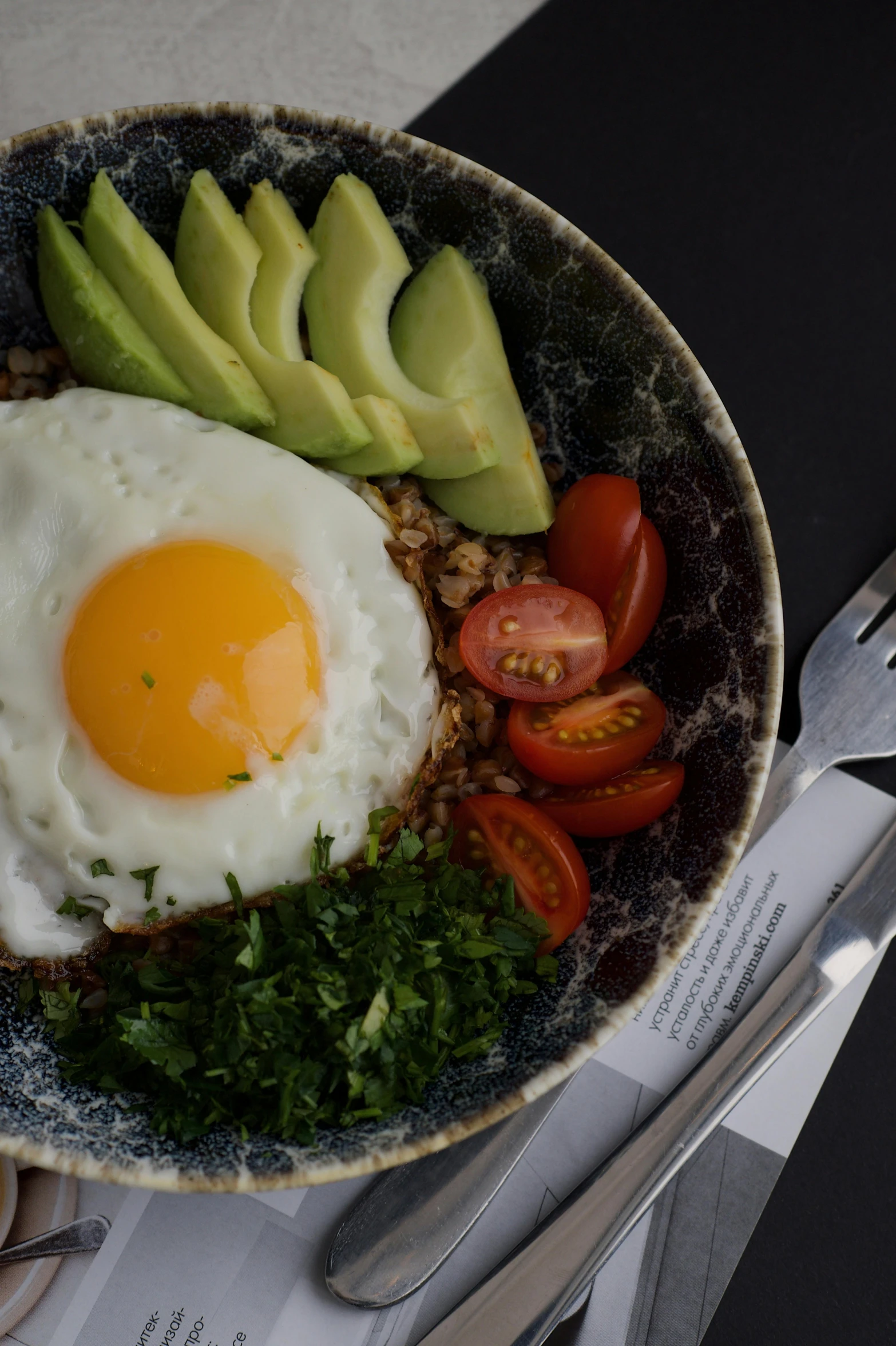 eggs, tomatoes, avocado and other fresh ingredients on a dish