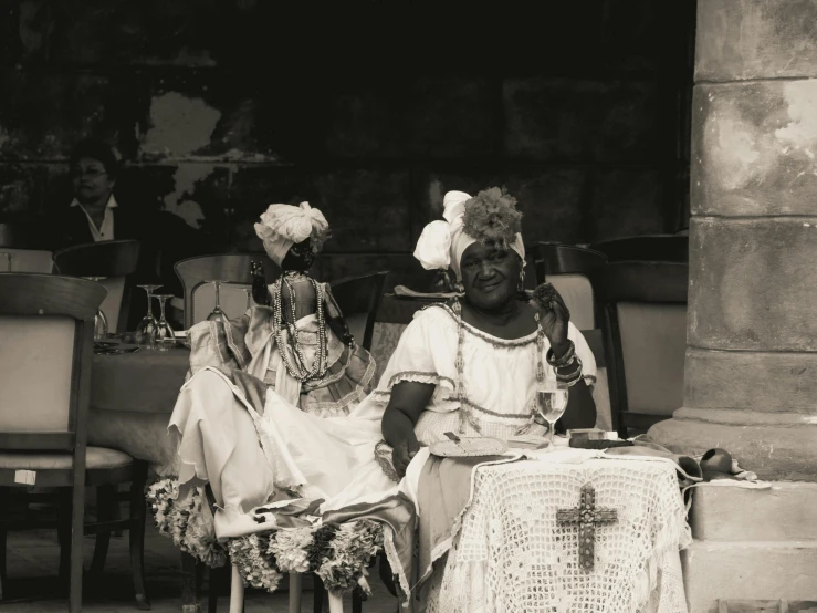 black and white image of two african american women sitting in their chairs