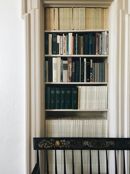 a bookshelf filled with lots of different colored books