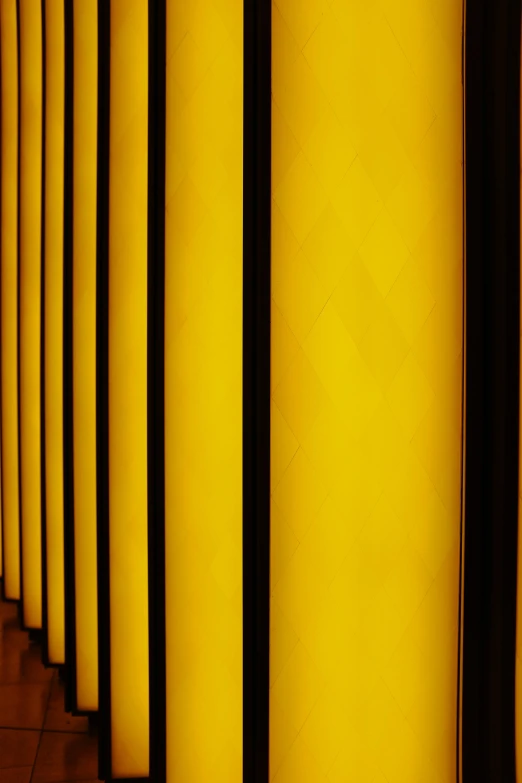 a line of empty yellow cylinder lined up against each other