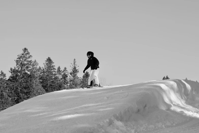 man doing tricks on snowboard in winter setting