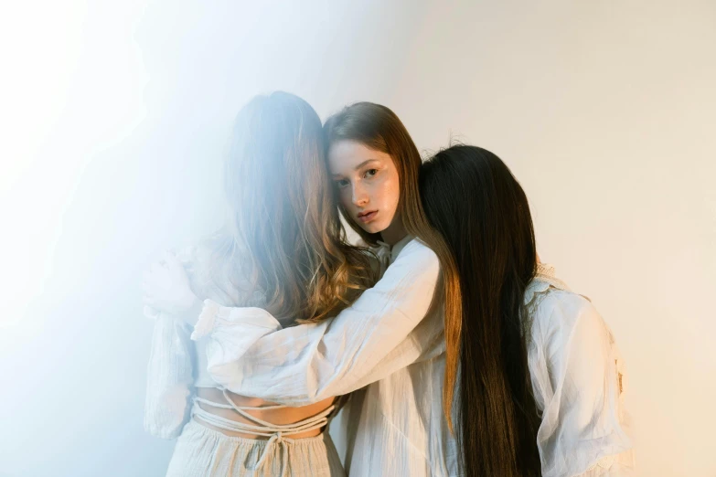 two young ladies are emcing while wearing white