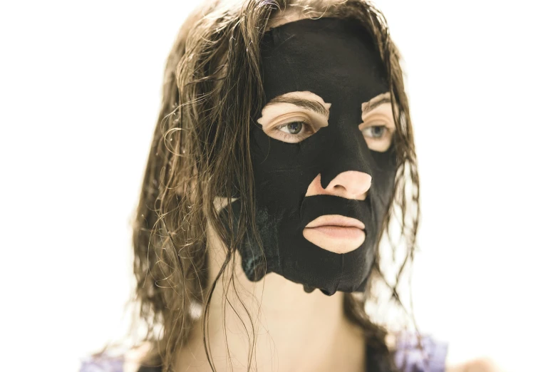 a woman's face with a black mask covering her face