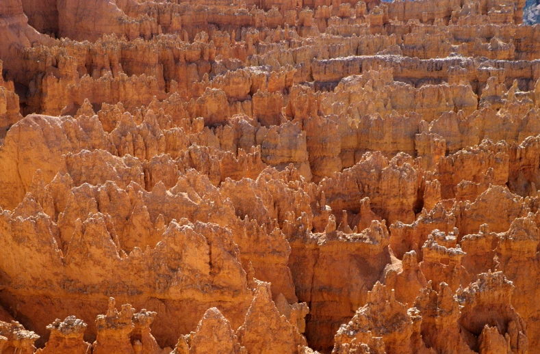 the view out an airplane window shows a rocky landscape