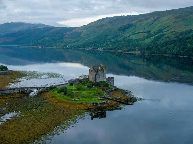 the castle is sitting on an island in the middle of the lake