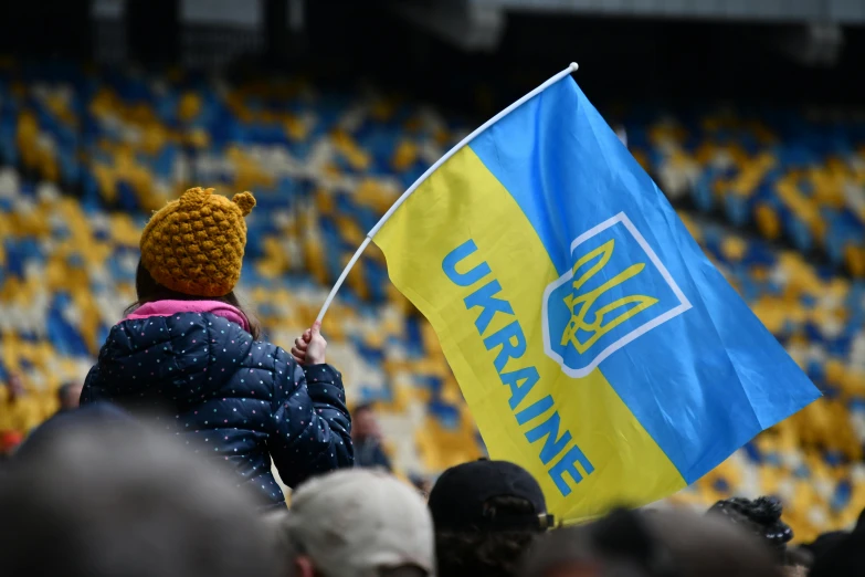 a young person holding an upplanne flag