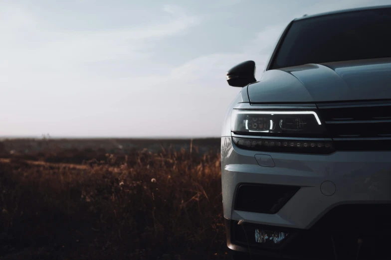 an off road truck parked in an empty field