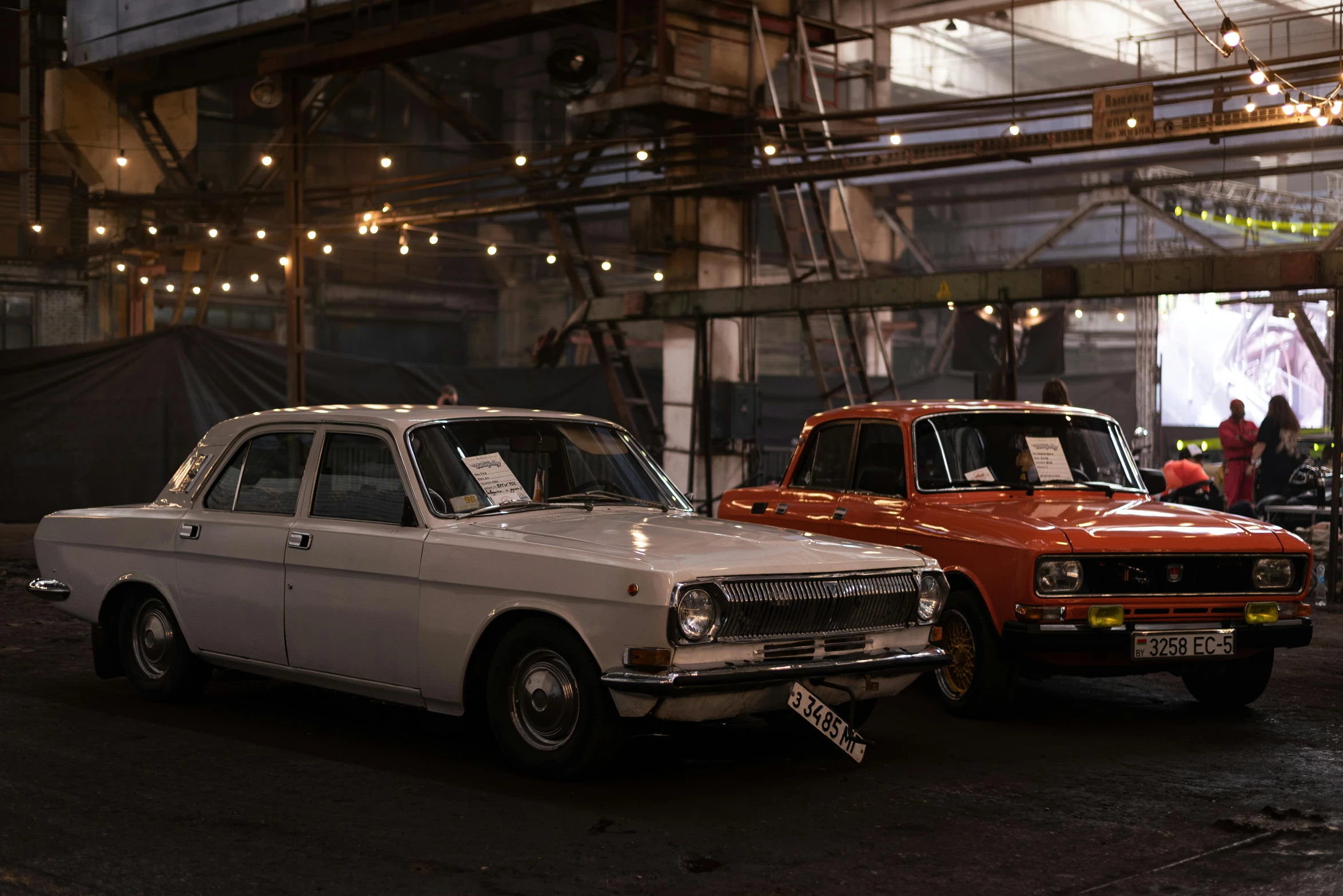 a pair of cars are shown parked in a garage