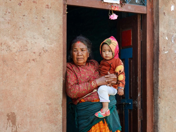 a woman and baby are in the doorway