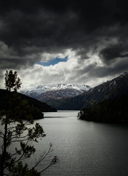 a lake is shown surrounded by mountains in the background