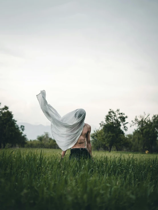 a person with a scarf is in the tall grass