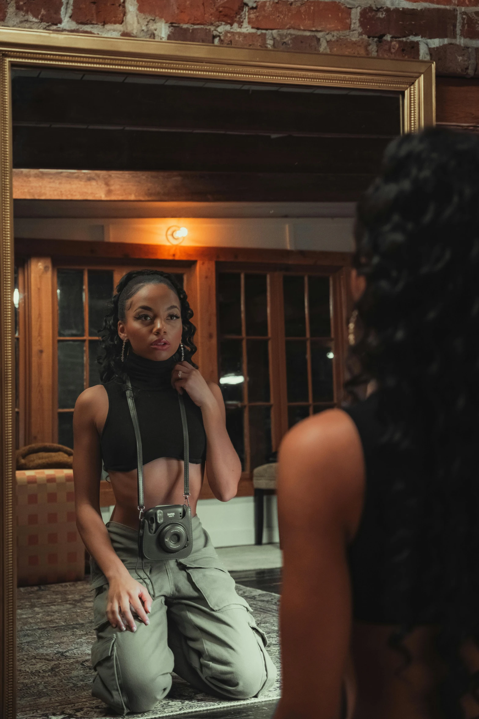 young lady looking in the mirror on top of the floor