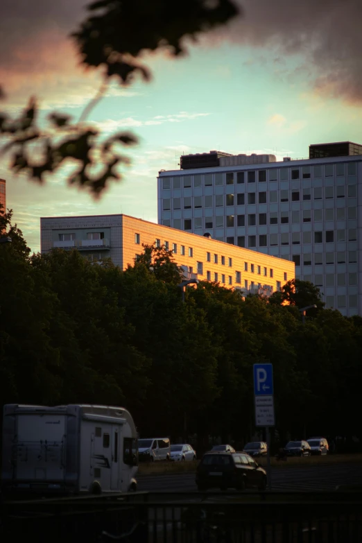 cars on a street with tall buildings in the background