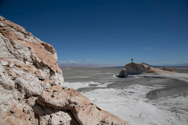 the lone person stands on the rock top