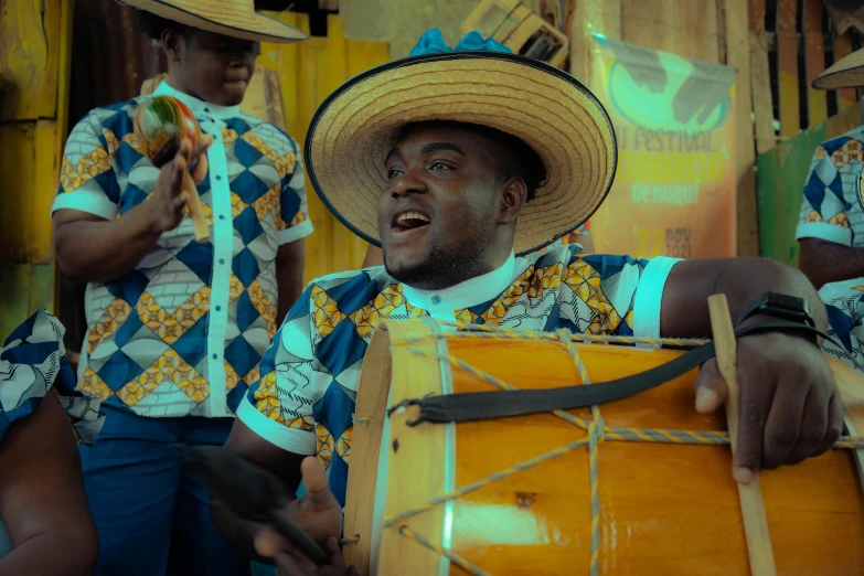 the man is sitting on his chair with the drum