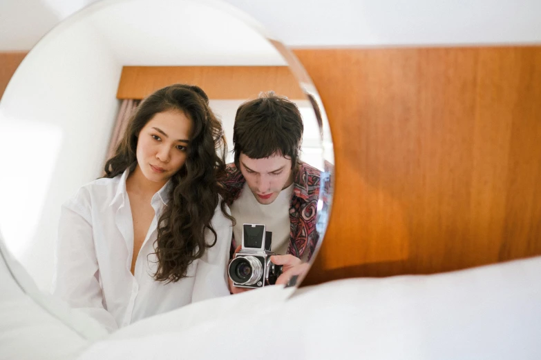 a man and woman taking a po with their camera