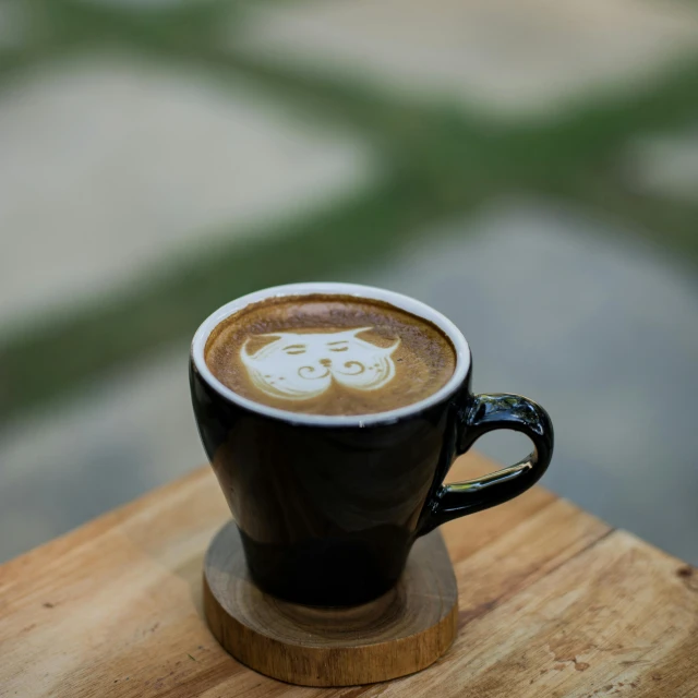 a cup with coffee on the top is on the table