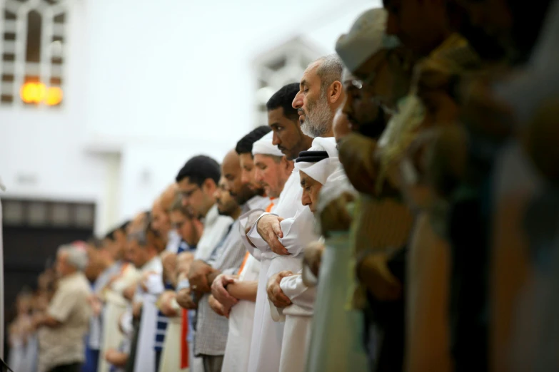 a row of men and women with white robes standing together