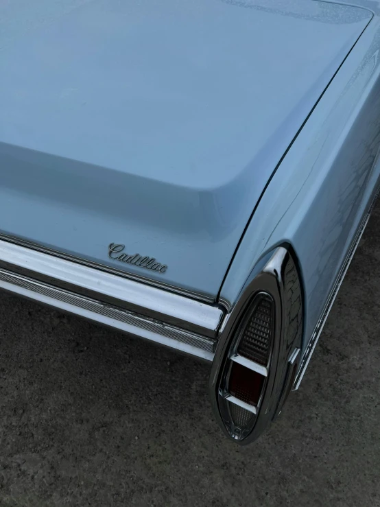 a light blue station wagon parked on the pavement