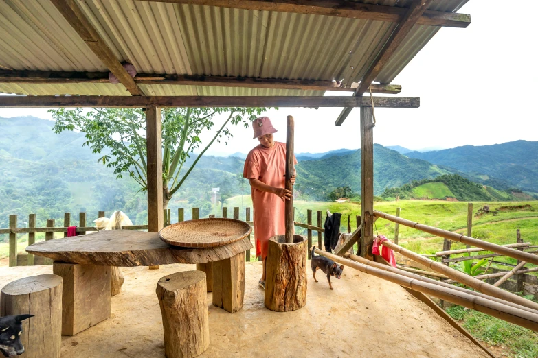 a woman with a hat standing in front of a wooden bench