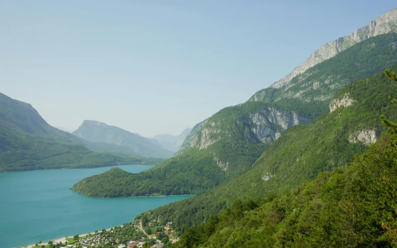 a bird's - eye view of a mountain lake surrounded by lush greenery