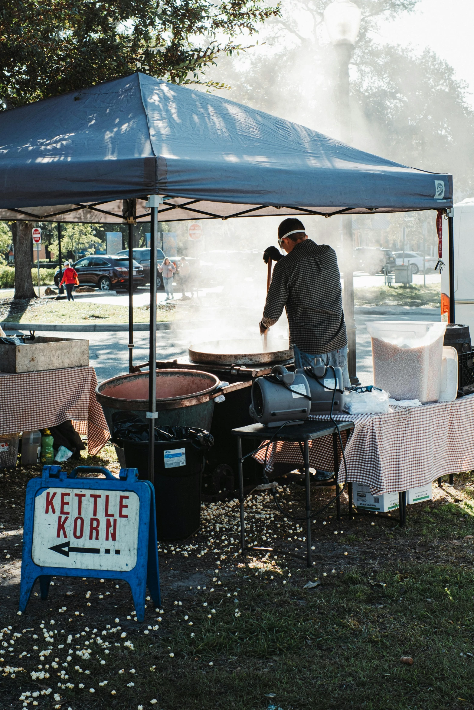 a man is cooking food under a tent