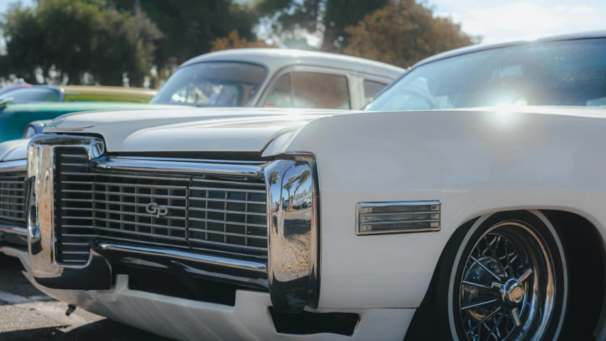 old cars are lined up on the street